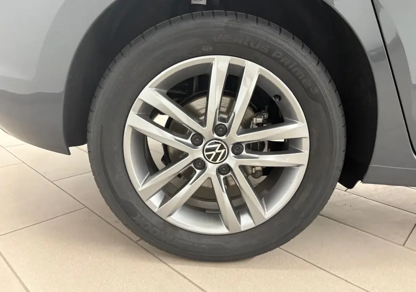 Gros plan sur la jante alliage 17 pouces du Volkswagen Touran gris dauphin, mettant en valeur le logo VW central.