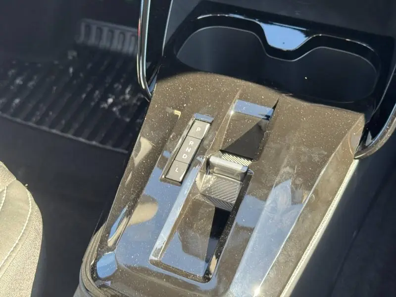 Gros plan sur la console centrale noire brillante avec levier de boîte automatique de la Citroën C3 Aircross 2026 hybride.