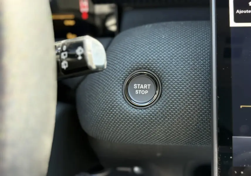 Bouton Start/Stop en gros plan sur tableau de bord texturé bleu du Citroën C5 Aircross NV Hybrid 2026.