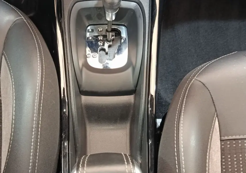 Vue plongeante sur la console centrale du Peugeot 2008 gris foncé, montrant le levier de boîte automatique et les sièges avant.