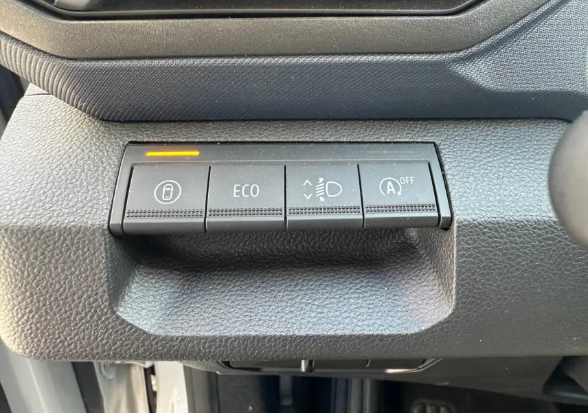 Gros plan sur les boutons de commande noirs du tableau de bord du Dacia Duster 2025, version Sandstone.