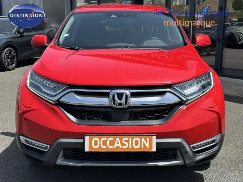 Vue avant d'un Honda CR-V rouge Rallye avec calandre chromée et feux LED, affichant une plaque "OCCASION".