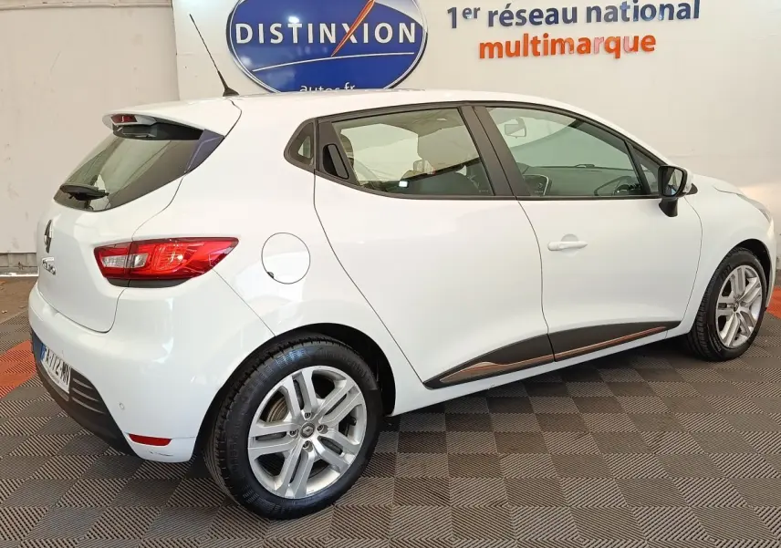 Renault Clio Business dCi 75 blanc vue 3/4 arrière droit, jantes alliage et feux arrière allumés.