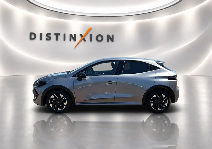 Renault Clio VI gris schiste vue de profil côté gauche, avec jantes alliage et vitres surteintées.
