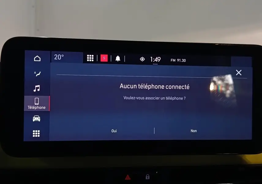 Écran tactile central affichant le menu téléphone du Fiat 500 BEV 24 kWh, intérieur moderne avec tableau de bord noir.