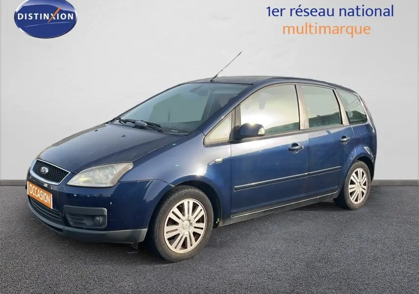 Ford C-MAX bleu foncé métal vu en 3/4 avant droit, montrant ses jantes alliage et ses lignes compactes.