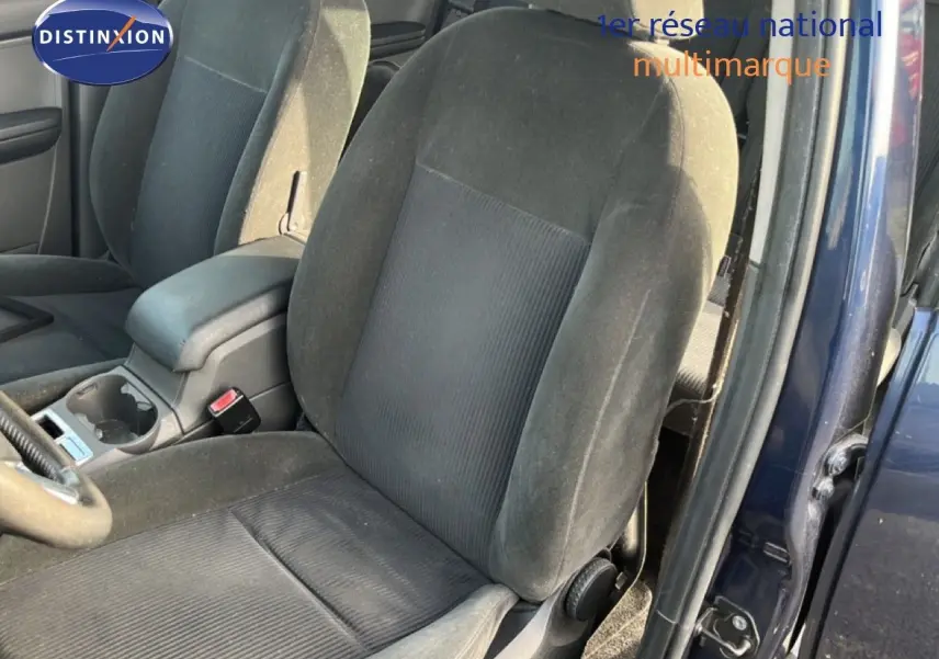Vue intérieure sur les sièges avant en tissu noir gris d'une Ford C-MAX bleu foncé, porte avant droite ouverte.
