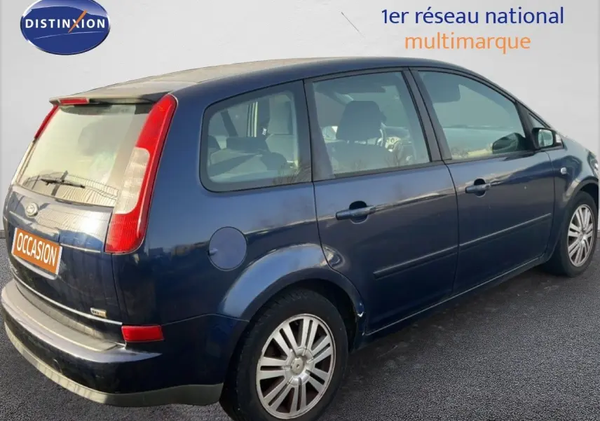 Vue 3/4 arrière droite d'une Ford C-MAX bleu foncé métallisé de 2005 avec hayon et feux arrière verticaux.