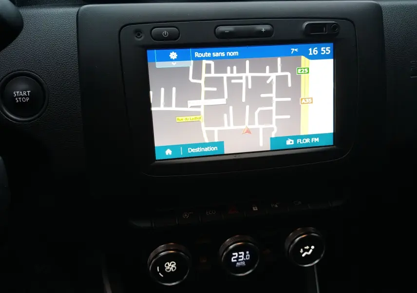 Vue rapprochée de l’écran tactile central et des commandes de climatisation du Dacia Duster 2021, intérieur noir.