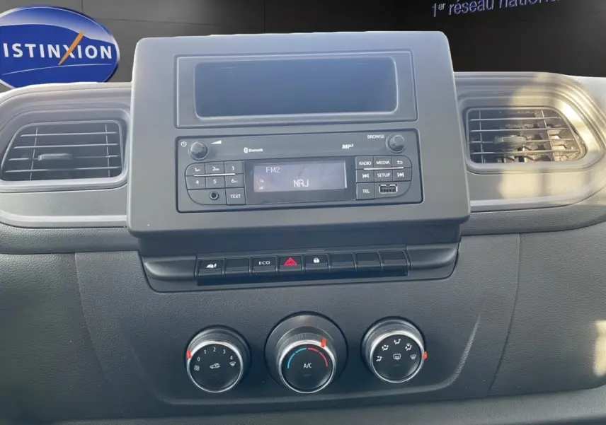 Tableau de bord du Renault Master 2024 avec radio Bluetooth, commandes climatisation et aérateurs noirs.