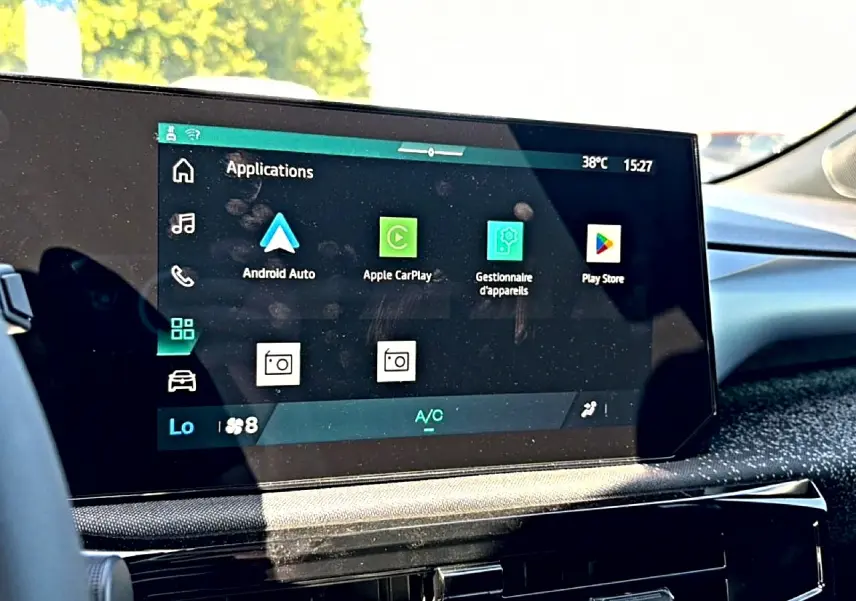 Écran tactile central de la Renault Clio VI noir, affichant les applications Android Auto et Apple CarPlay, intérieur lumineux.