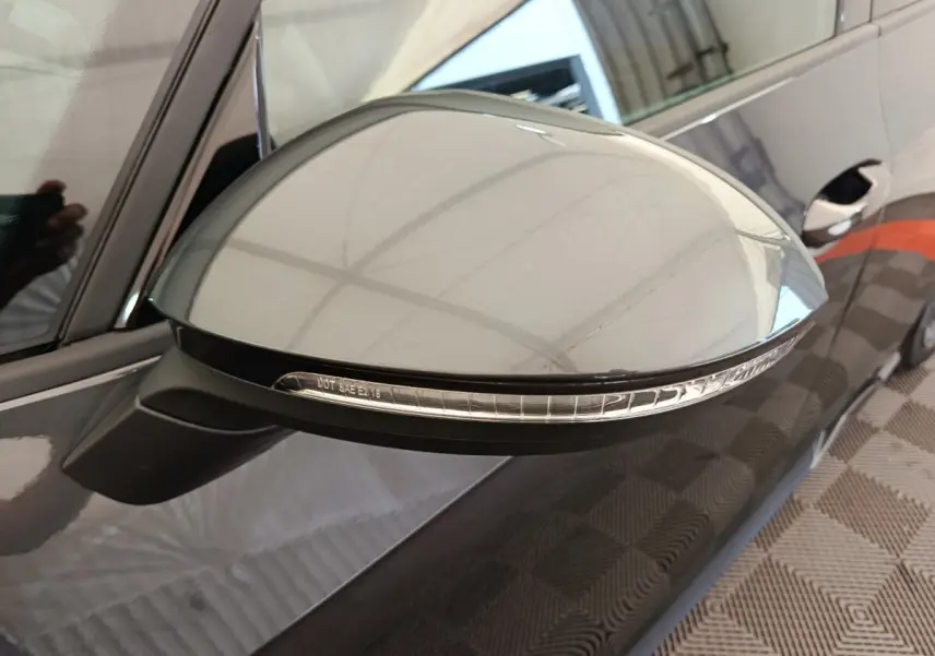 Rétroviseur côté gauche gris foncé de la CUPRA BORN 230ch 2023 avec clignotant intégré, vue rapprochée en intérieur.