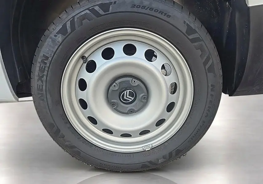 Gros plan sur la roue avant droite du Citroën Berlingo Fourgon blanc, jante acier grise avec logo Citroën central.
