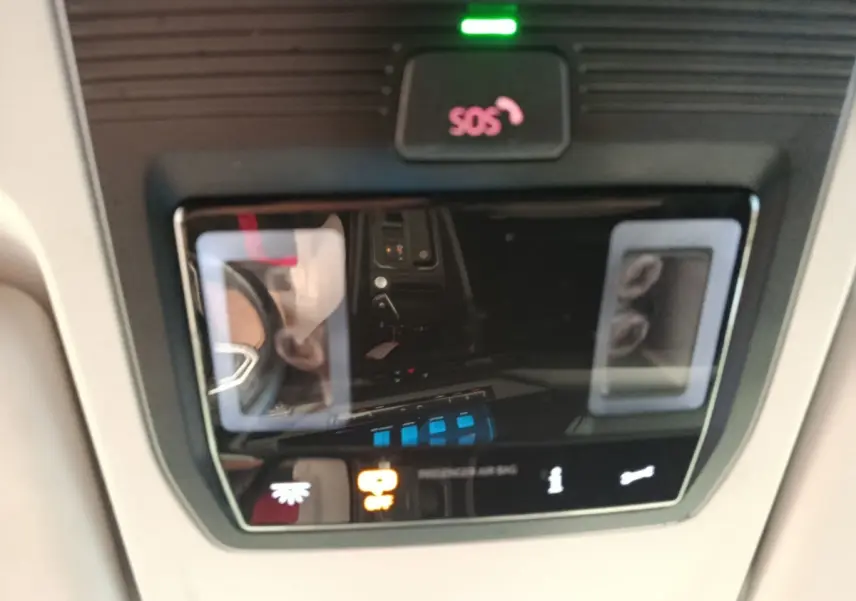 Vue rapprochée du panneau de commande intérieur avec bouton SOS et indicateurs lumineux dans un Volkswagen Caddy blanc 2022.