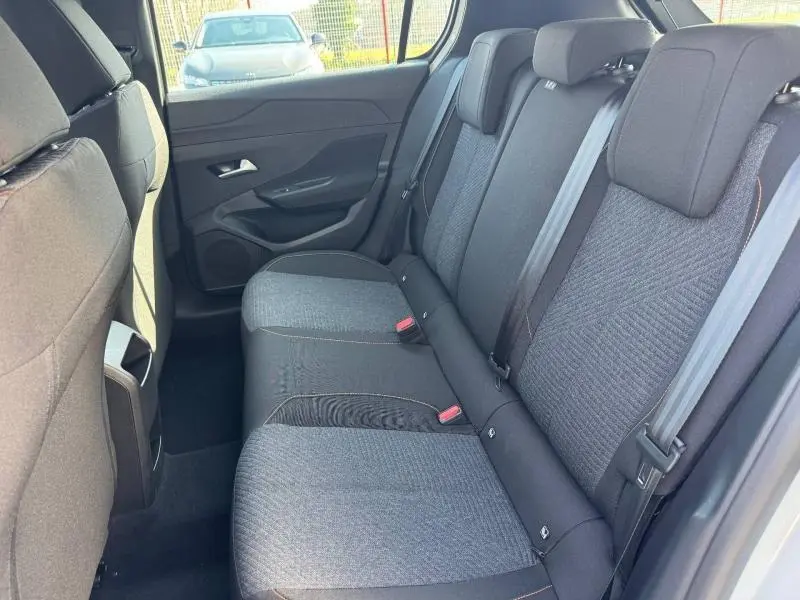 Vue intérieure arrière côté droit de la banquette tissu gris avec ceintures et appuie-têtes de la Peugeot 308 blanc Okénite 2025.