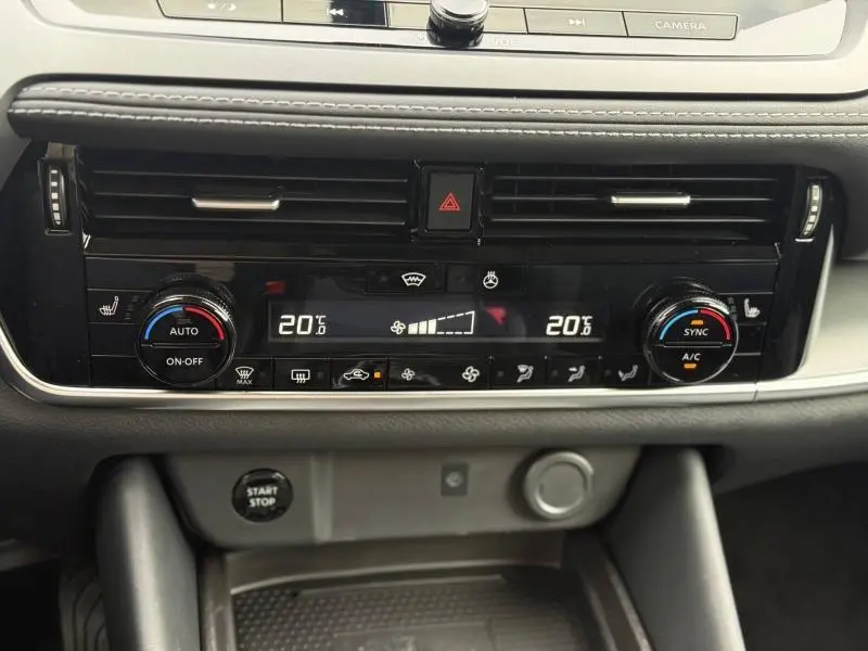 Tableau de bord du Nissan Qashqai Hybrid e-POWER 2025 montrant la console de climatisation digitale avec réglages à 20°C.
