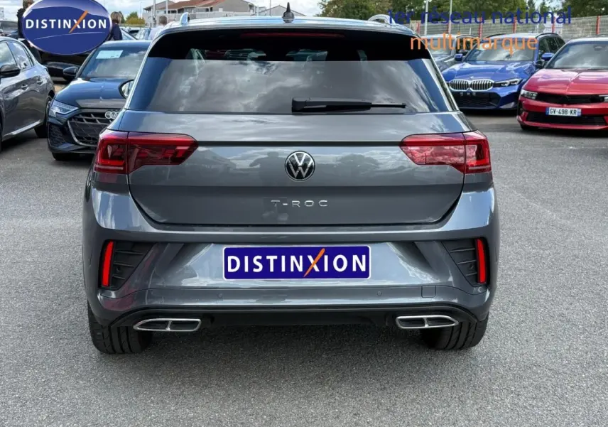 Vue arrière d'un Volkswagen T-Roc gris Indium métallisé avec double sortie d'échappement chromée et feux LED.
