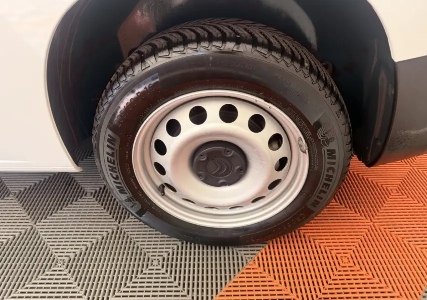 Gros plan sur la roue avant droite blanche d’un Citroën Berlingo 2022 avec jante acier et pneu Michelin.