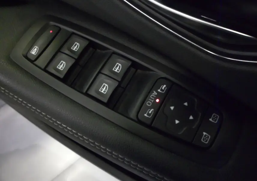 Gros plan sur les commandes de lève-vitres et rétroviseurs côté conducteur du Renault Grand Scenic IV blanc Glacier.