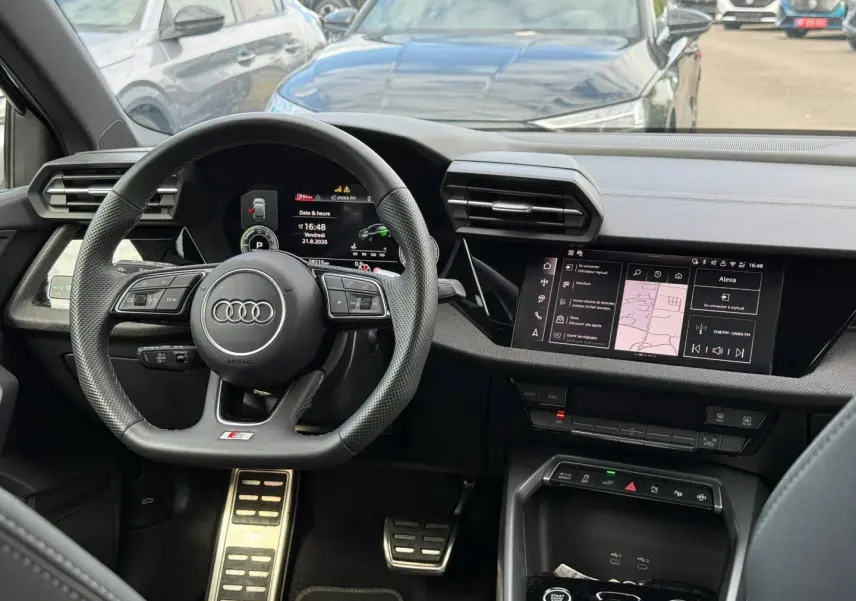 Vue intérieure centrée sur le volant sport et le tableau de bord numérique de l'Audi A3 Sportback 2025.
