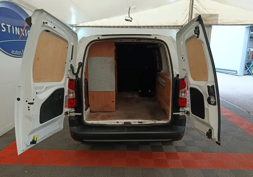 Vue arrière d’un Citroën Berlingo XL blanc 2020 avec portes arrière ouvertes et aménagement bois dans le coffre.