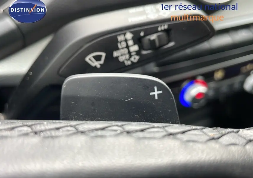 Gros plan sur la palette de changement de vitesse "+" du volant en cuir de l'Audi Q2 35 TFSI S-Line 2023.