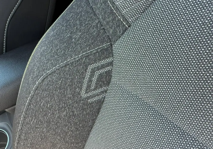 Gros plan sur la sellerie grise avec motif géométrique du siège avant droit du Renault Captur 2025.