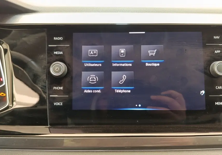 Écran tactile central affichant le menu des aides à la conduite dans l’habitacle du Volkswagen Taigo gris foncé.