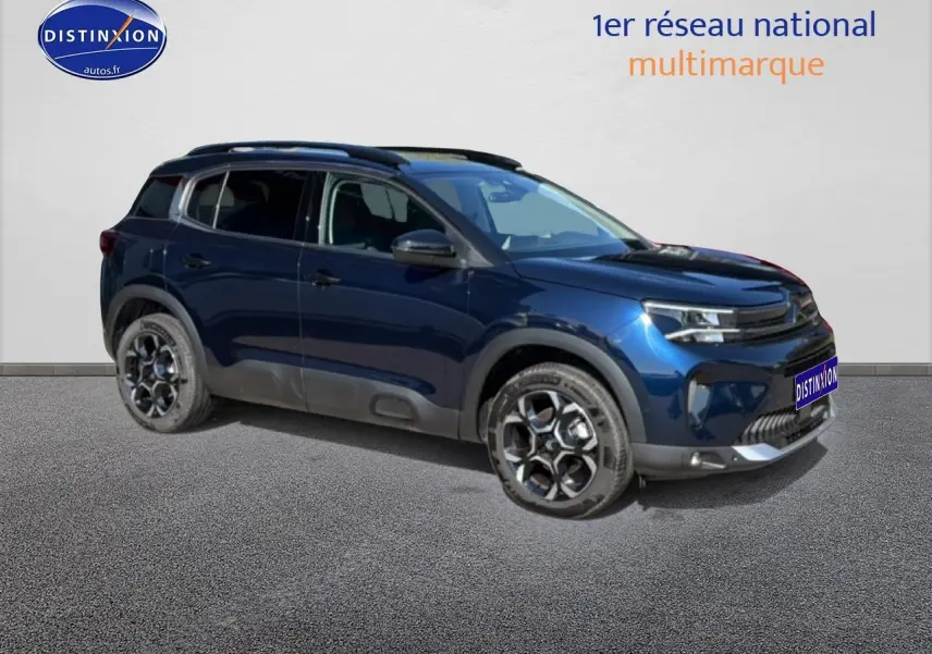 Citroën C5 Aircross bleu eclipse vue 3/4 avant droit avec jantes alu et barres de toit visibles.