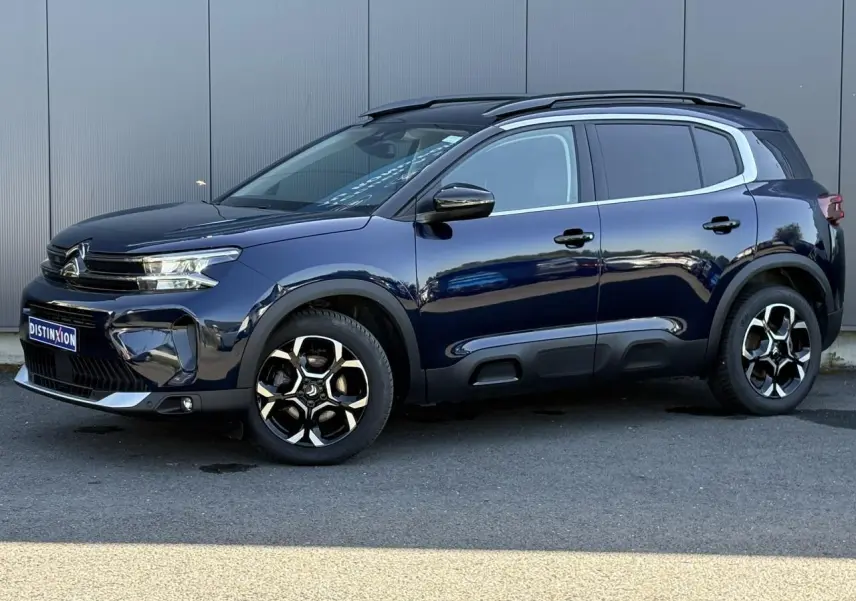 Citroën C5 Aircross Hybrid bleu Eclipse vue de profil côté gauche avec jantes alliage bi-ton et barres de toit noires.