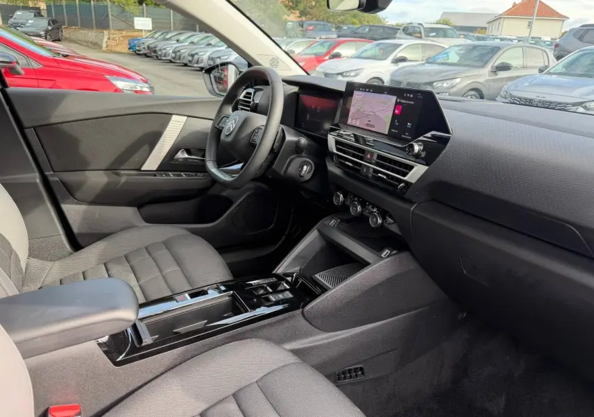 Vue intérieure côté conducteur de la Citroën C4 1.2 Hybride 2025 avec tableau de bord noir et écran tactile central.