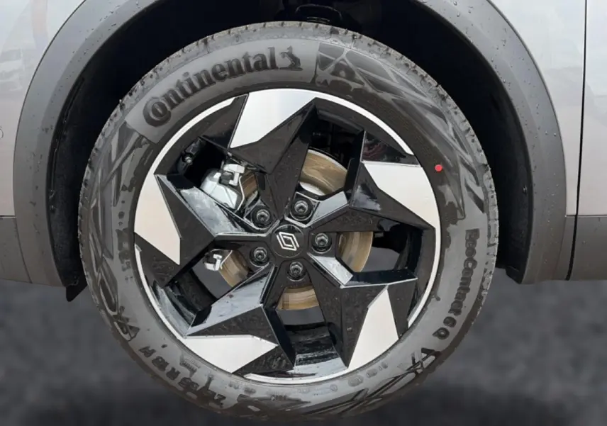 Gros plan sur la roue avant gauche du Renault Captur 2026, jante alu noire et argent avec logo Renault central.