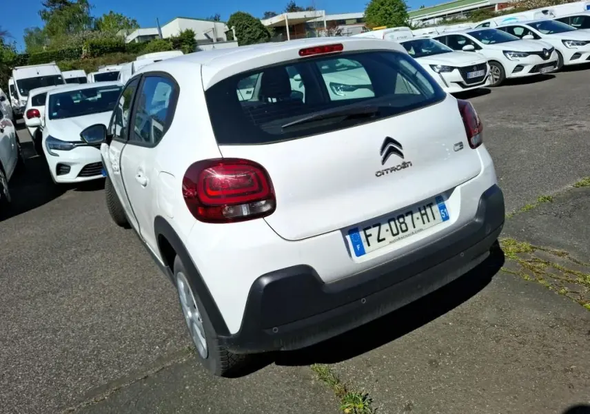 Vue 3/4 arrière droite d'une Citroën C3 Société blanche avec feux arrière distinctifs et pare-chocs noir.