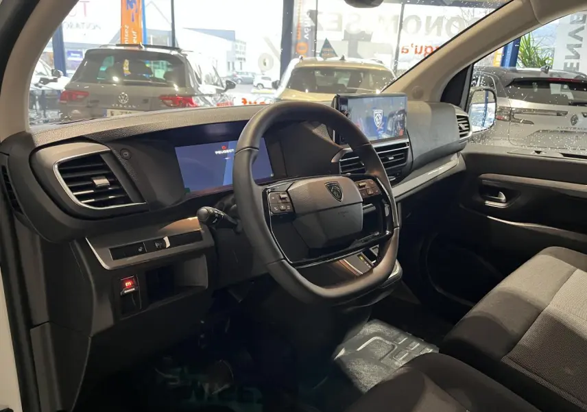 Vue intérieure côté conducteur du Peugeot Expert Fourgon 2024 avec volant cuir, combiné numérique et écran tactile.