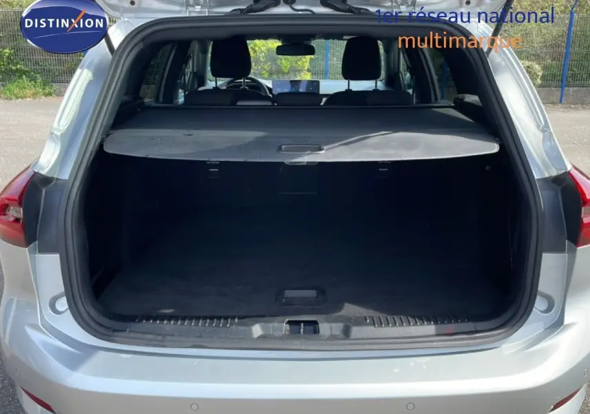 Coffre ouvert vu de l'arrière d'une Ford Focus SW 1.0 EcoBoost MHEV 125ch ST-Line X gris lunaire métal, intérieur noir.