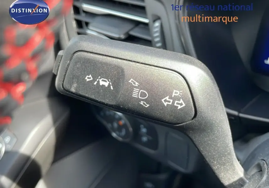 Gros plan sur la commande de clignotants et aides à la conduite dans l’habitacle d’une Ford Focus SW gris lunaire 2023.
