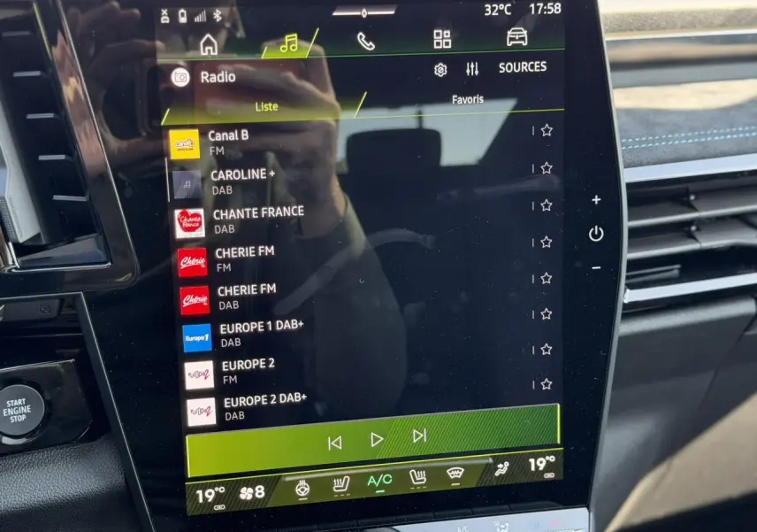Vue rapprochée de l’écran tactile central du Renault Austral E-Tech, affichant les stations radio avec détails lumineux.