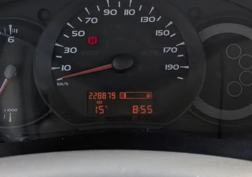Vue rapprochée du tableau de bord du Renault Kangoo II 1.5 DCi 85, affichant le compteur et l'odomètre à 228879 km.