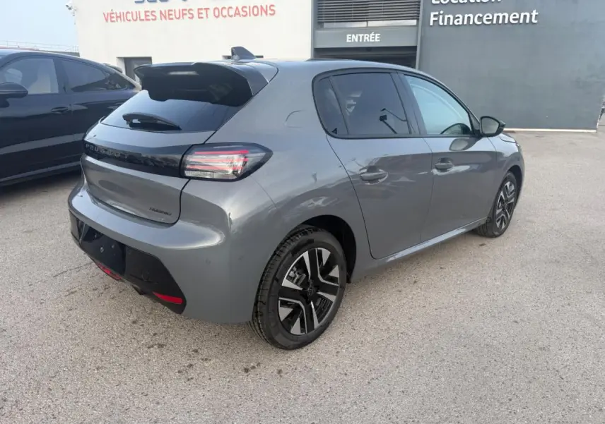 Vue 3/4 arrière droite d'une Peugeot 208 Hybrid 110 gris métallisé avec jantes alliage 16 pouces et antenne requin.