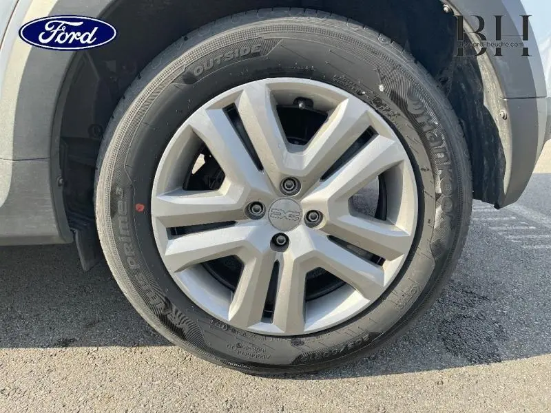 Gros plan sur la roue avant gauche de la Dacia Sandero blanche, mettant en valeur la jante 16 pouces Mahalia.