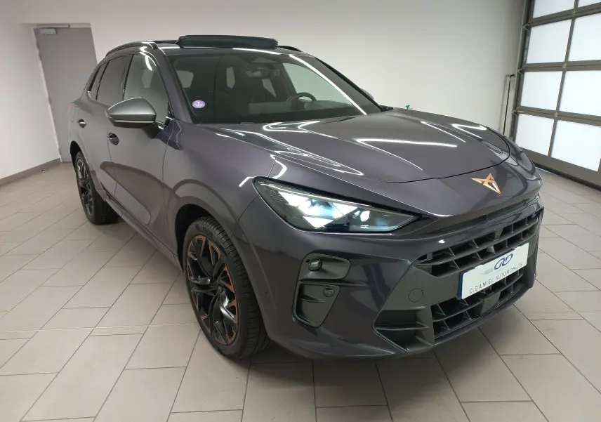 Vue 3/4 avant droit d'un CUPRA TERRAMAR violet intersidéral avec jantes cuivrées et toit ouvrant panoramique en intérieur showroom.