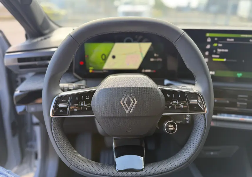 Vue centrée sur le volant cuir noir de la Renault Clio VI TCe 115 Techno avec tableau de bord numérique et écran tactile.