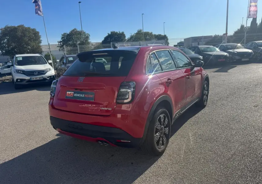 Vue 3/4 arrière droite d'une FIAT 600 T-Gen 3 rouge 2025 avec feux arrière à LED et jantes noires stylisées.