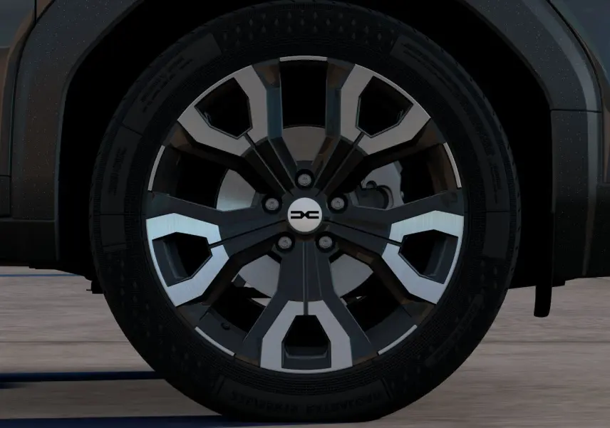 Gros plan sur la roue avant droite du Dacia Bigster noir nacré 2026, mettant en valeur la jante au design moderne bicolore.