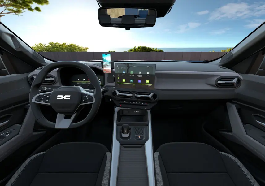 Vue intérieure avant du Dacia Bigster Hybrid 155 Journey noir nacré, avec tableau de bord moderne et écran tactile central.