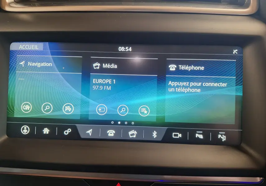 Écran tactile central affichant navigation, média et téléphone dans Jaguar E-PACE blanc, vue intérieure rapprochée.