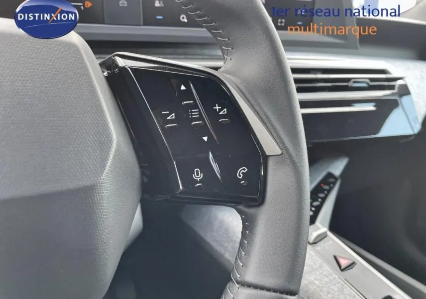 Gros plan sur le volant cuir noir du Peugeot 3008 2025 avec commandes tactiles intégrées côté gauche.
