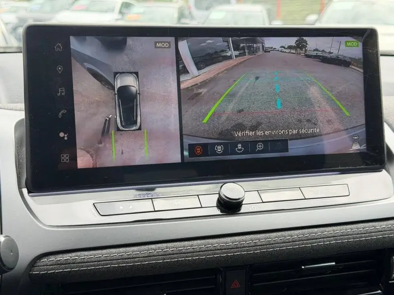 Écran tactile intérieur du Nissan Qashqai 2025 montrant la caméra de recul et vue 360° en gris Argile.