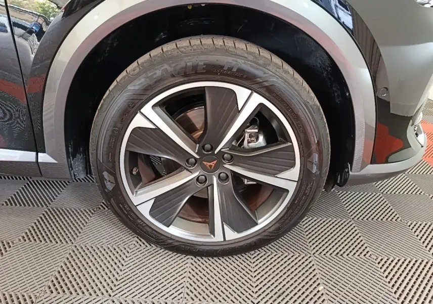 Gros plan sur la roue avant gauche noire du CUPRA Formentor 1.4 e-HYBRID 2024 avec jante alliage bicolore distinctive.