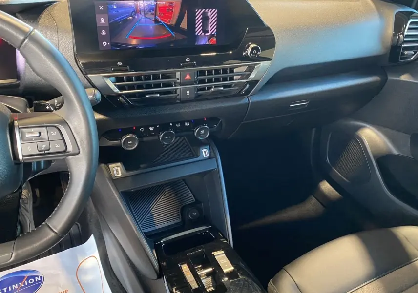 Intérieur noir de la Citroën C4 2023, vue du tableau de bord et console centrale avec écran tactile affichant la caméra de recul.